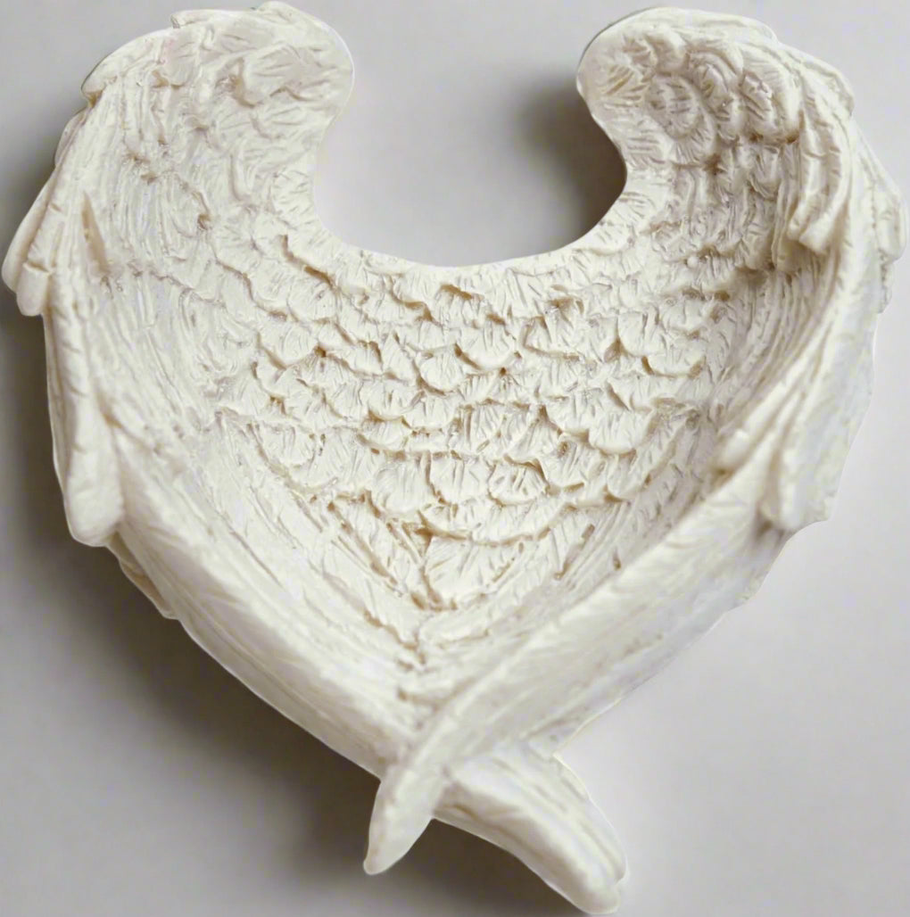 The Angel Wing Bowl stands as a testament to the seamless fusion of artistic finesse and practicality. Crafted with attention to detail from high-quality resin, this bowl showcases a level of craftsmanship that is both awe-inspiring and enduring. Every delicate contour of the angel wings, every intricately etched feather, reflects a dedication to quality that is evident from the first glance. candle holder crystal dish