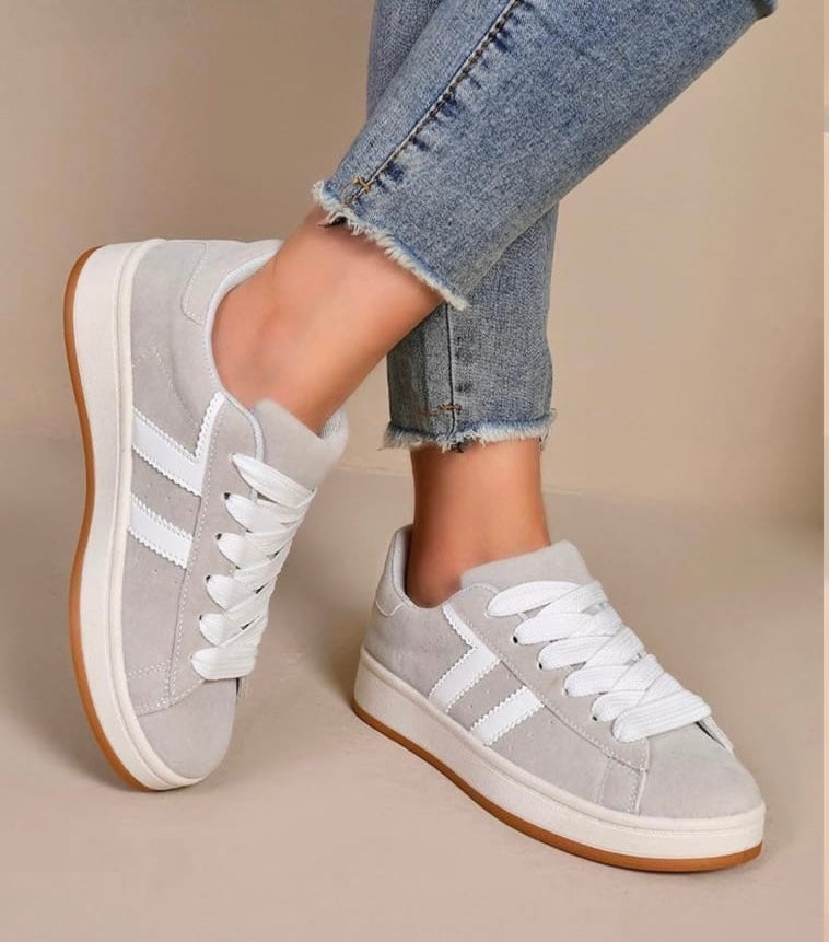 Eve is a chunky sole skater style trainer, available in Grey or black with 2 white stripes on the side & a gum plated sole for the retro look.