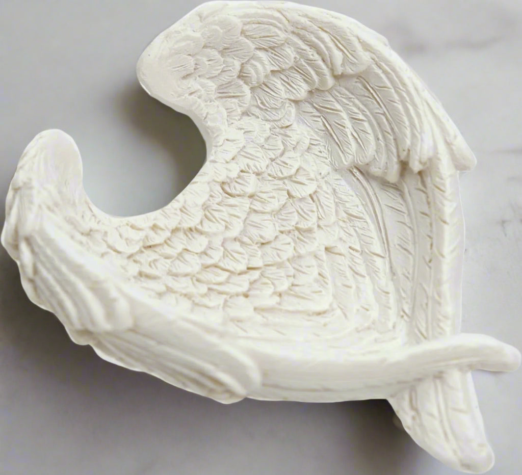 The Angel Wing Bowl stands as a testament to the seamless fusion of artistic finesse and practicality. Crafted with attention to detail from high-quality resin, this bowl showcases a level of craftsmanship that is both awe-inspiring and enduring. Every delicate contour of the angel wings, every intricately etched feather, reflects a dedication to quality that is evident from the first glance. candle holder crystal dish 